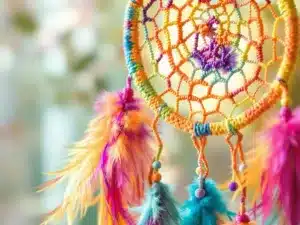 Colorful crochet dream catcher with feathers and yarn.