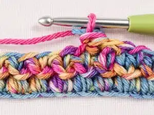 Close-up of double crochet stitch in colorful yarn.