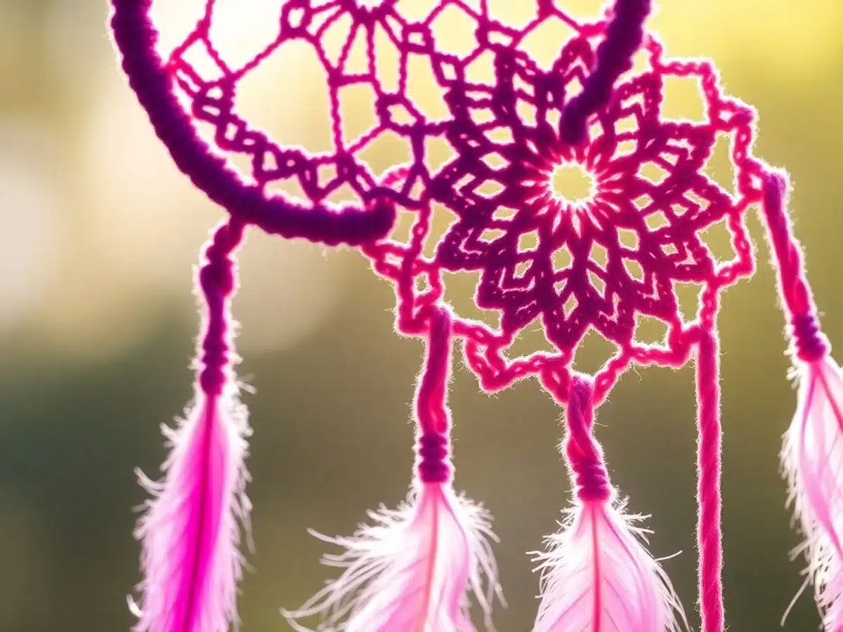 Colorful dream catcher with crochet patterns and feathers.