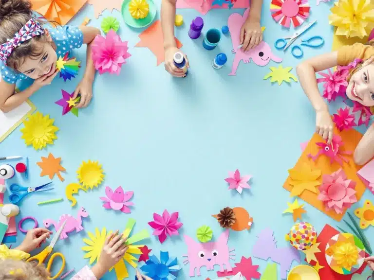 Children crafting colorful paper projects with joy and creativity.