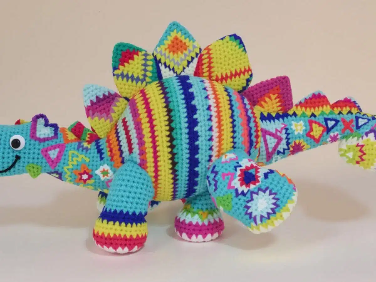 Colorful crochet dinosaur with intricate patterns and textures. Bizarre Crochet