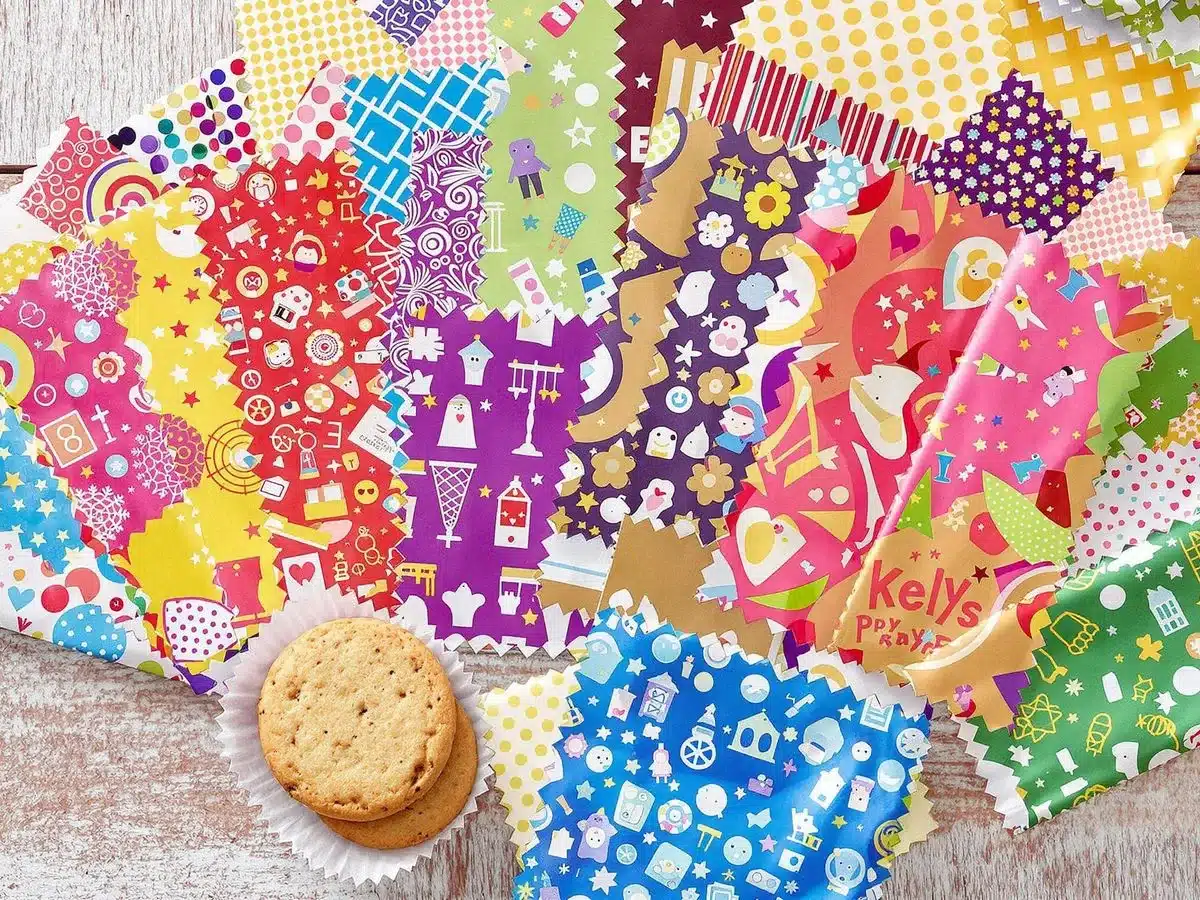 Colorful cookie wrappers in various designs on a table.